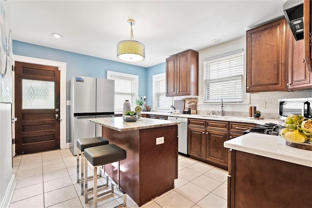 507 E 75th St, Kansas City, MO 64131 - kitchen with light tile patterned flooring, dishwasher, a sink, and freestanding refrigerator