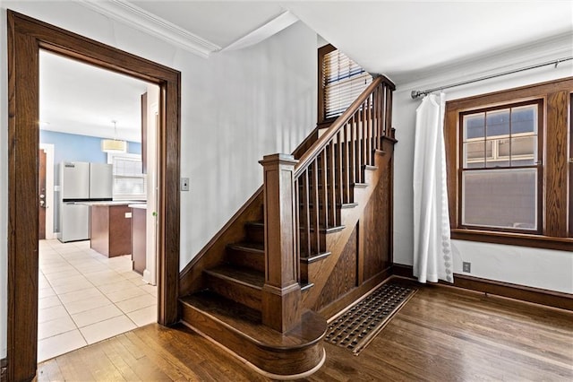 507 E 75th St, Kansas City, MO 64131 - staircase with baseboards, wood finished floors, and crown molding