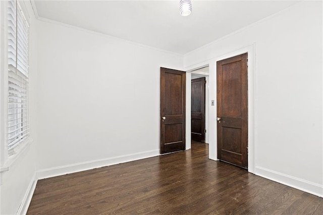 507 E 75th St, Kansas City, MO 64131 - spare room featuring dark wood-type flooring, crown molding, and baseboards
