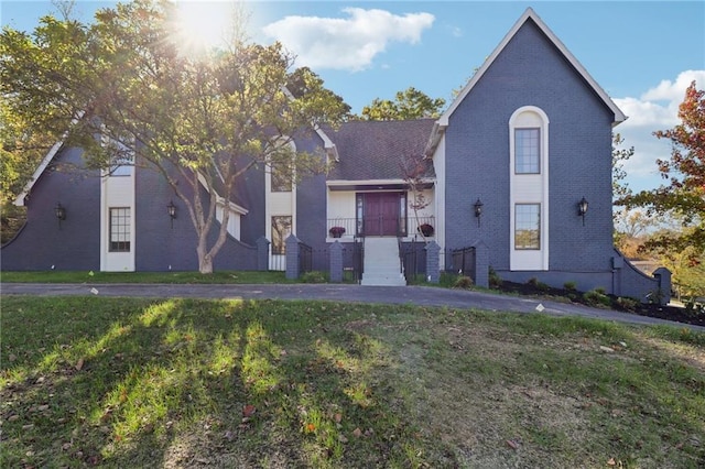 view of front of property with a front lawn and brick siding