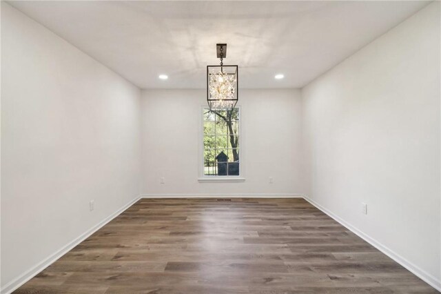 unfurnished room with dark hardwood / wood-style flooring