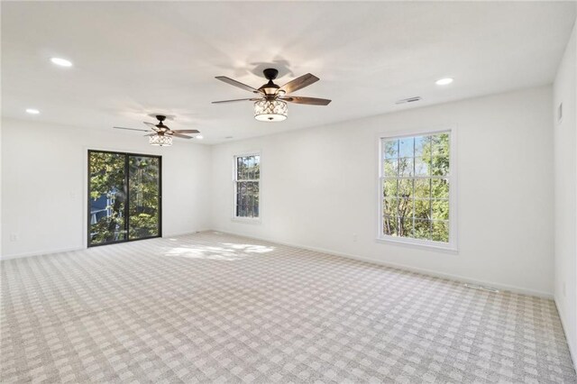 spare room with light carpet and ceiling fan