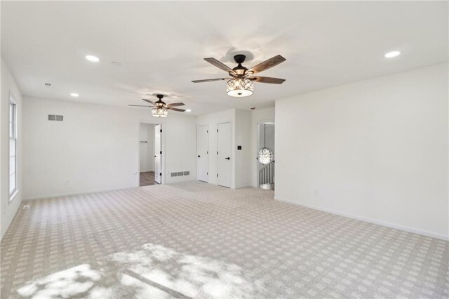 spare room with light carpet and ceiling fan