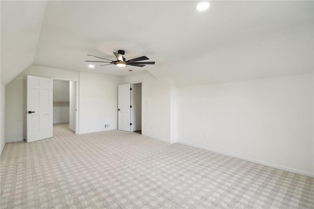 bonus room with vaulted ceiling, light carpet, and ceiling fan