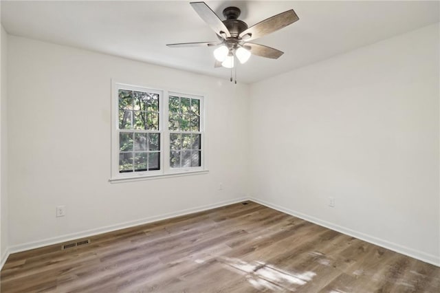 empty room with wood-type flooring and ceiling fan