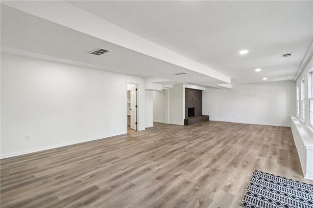 unfurnished living room featuring a fireplace and light wood-type flooring