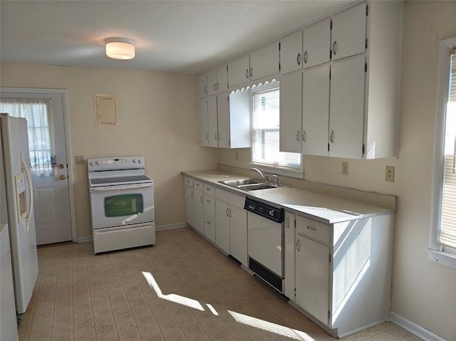 517 1st St, Platte City, MO 64079 - kitchen featuring light countertops, white appliances, baseboards, light floors, and a sink