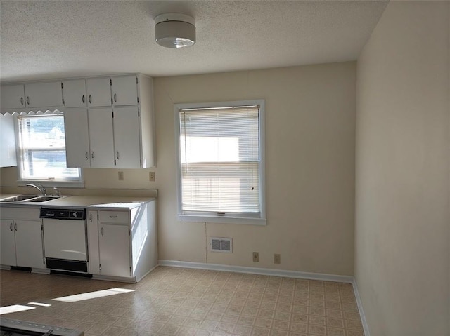 517 1st St, Platte City, MO 64079 - kitchen with visible vents, dishwasher, baseboards, light floors, and a sink