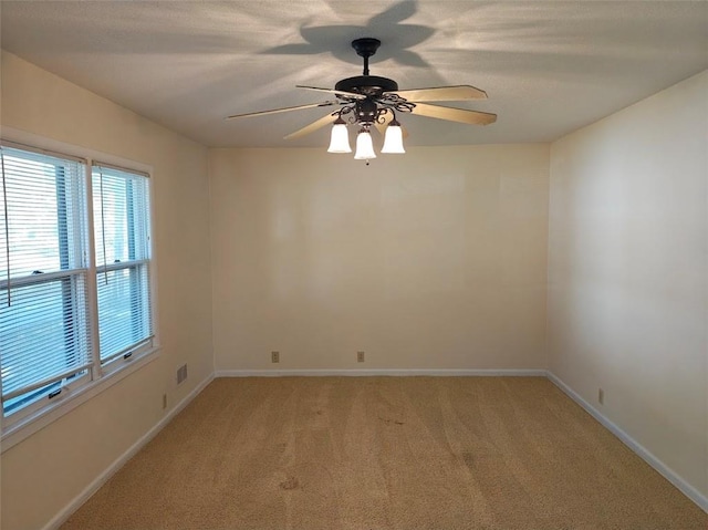 empty room featuring light carpet and ceiling fan