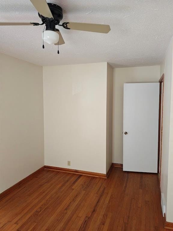 517 1st St, Platte City, MO 64079 - spare room with a textured ceiling, baseboards, ceiling fan, and wood finished floors