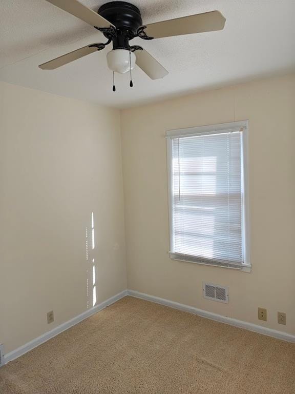 carpeted empty room with ceiling fan