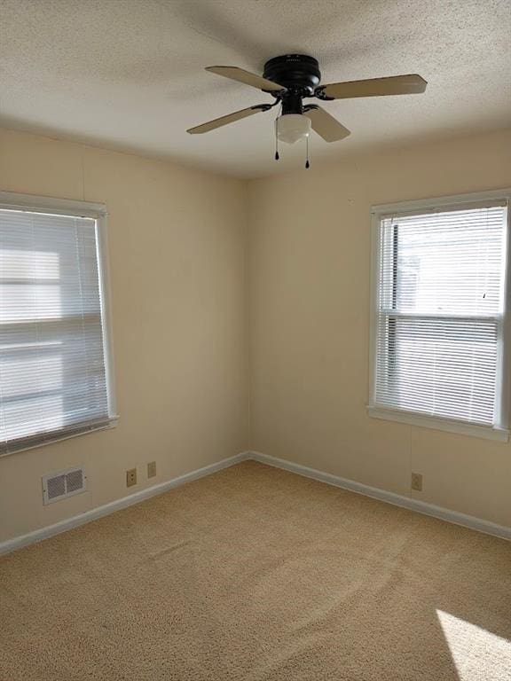 517 1st St, Platte City, MO 64079 - unfurnished room with a ceiling fan, a textured ceiling, baseboards, light colored carpet, and visible vents