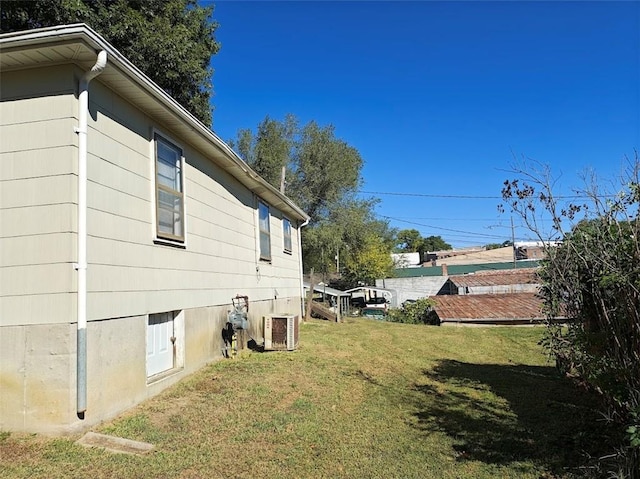 view of home's exterior with a lawn and cooling unit