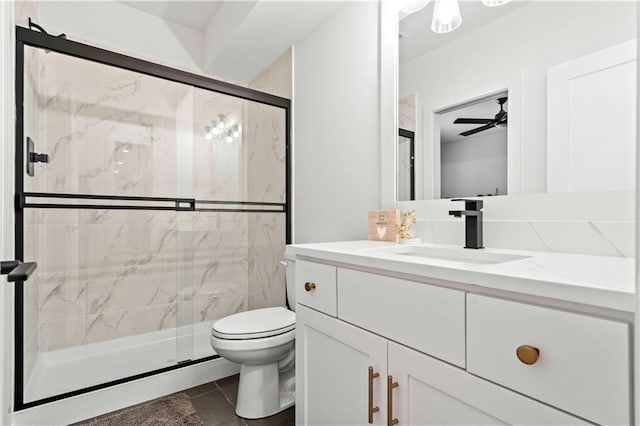 bathroom featuring ceiling fan, an enclosed shower, toilet, and vanity