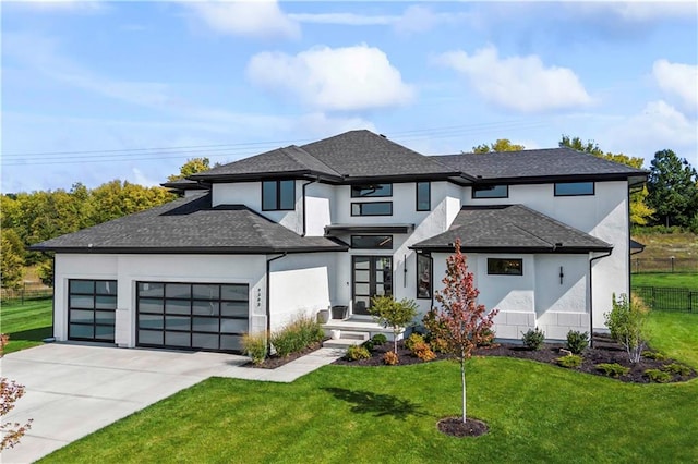 prairie-style house featuring a front yard and a garage