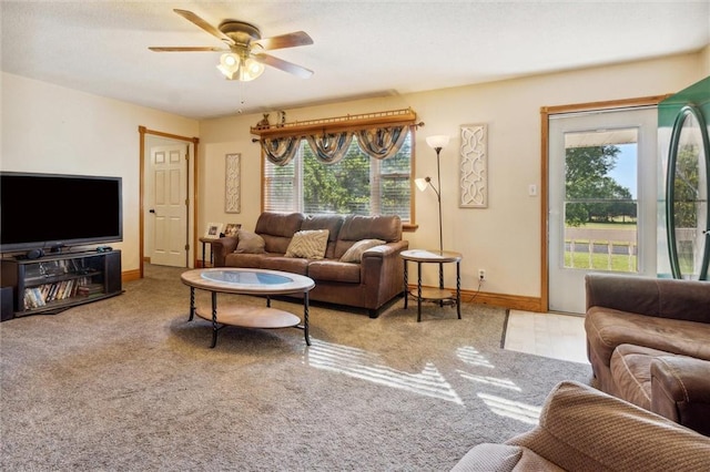 living room featuring light carpet, ceiling fan, and a healthy amount of sunlight