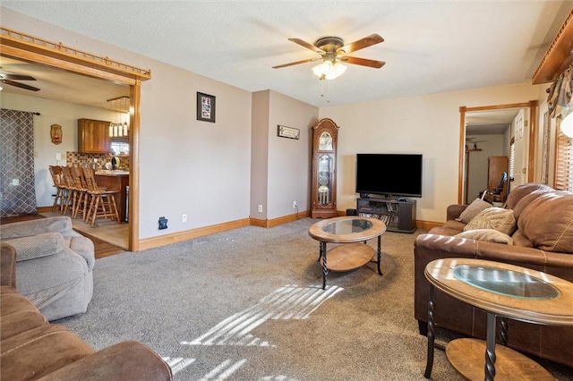 carpeted living room featuring ceiling fan