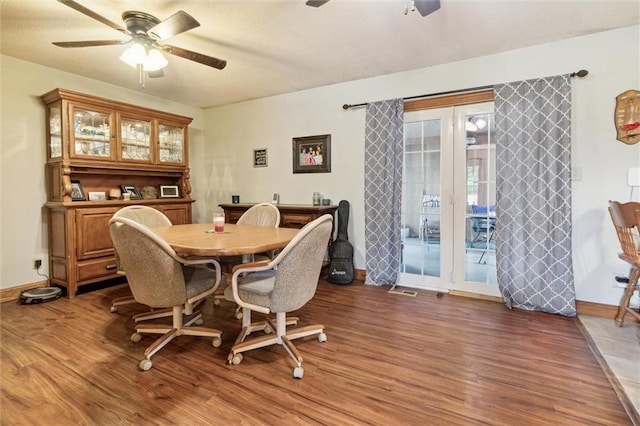 dining area featuring ceiling fan and dark wood-type flooring