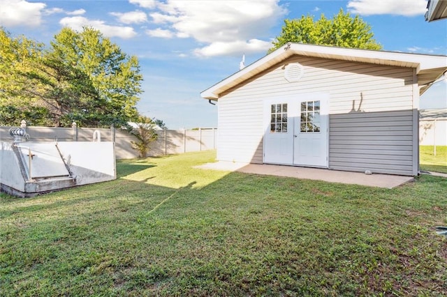 exterior space featuring a lawn and an outbuilding