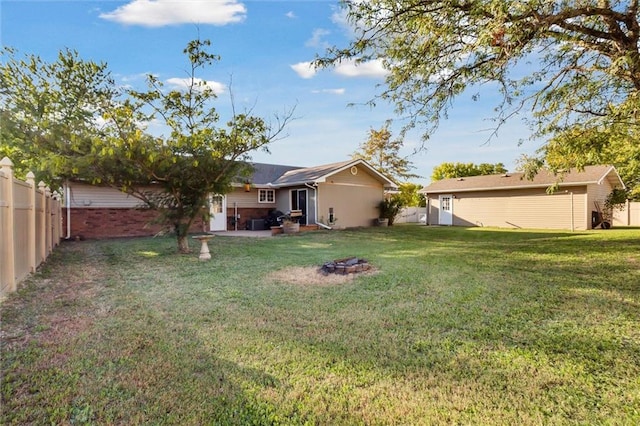 view of yard featuring a patio and a fire pit