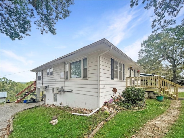 view of side of property with a deck and a yard