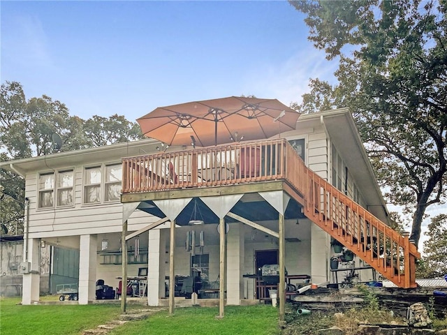 back of property featuring a deck and a yard