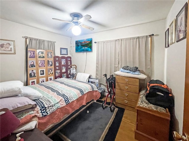 bedroom with ceiling fan and hardwood / wood-style floors