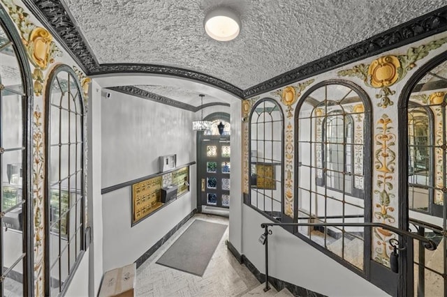 interior space featuring a notable chandelier, crown molding, and parquet floors