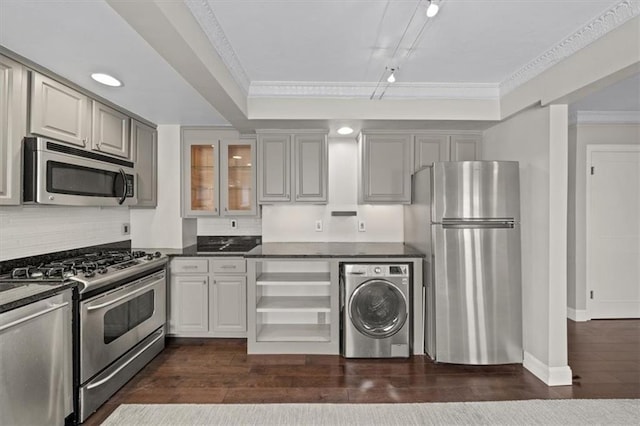 kitchen with gray cabinets, appliances with stainless steel finishes, dark hardwood / wood-style floors, and washer / dryer