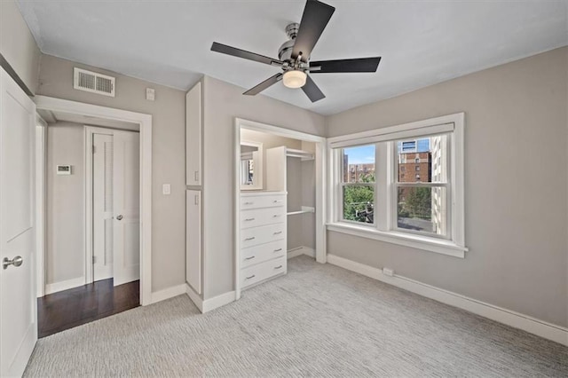 unfurnished bedroom with ceiling fan and light colored carpet