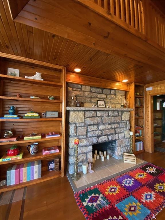 interior space with wood-type flooring, a fireplace, and wood ceiling