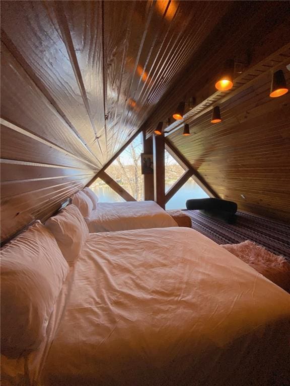 unfurnished bedroom with wood ceiling and wood walls