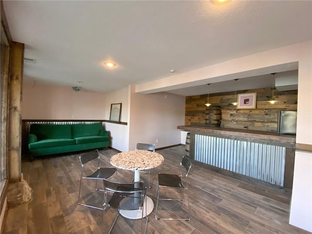 interior space featuring dark hardwood / wood-style flooring and wooden walls