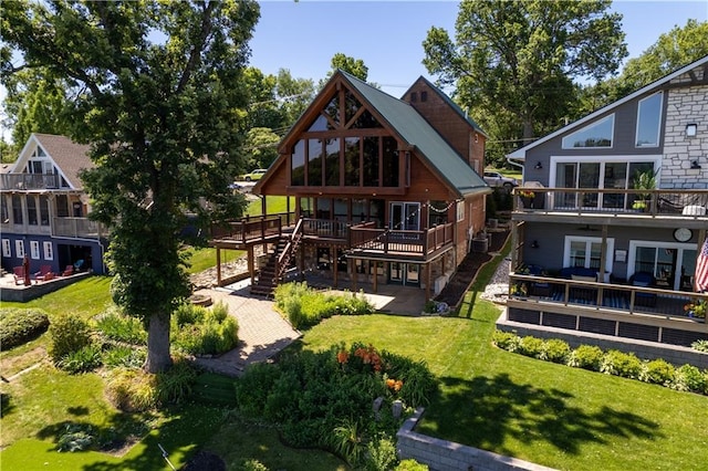 27 Beach Dr, Lake Tapawingo, MO 64015 - rear view of house featuring a wooden deck, a lawn, and stairway