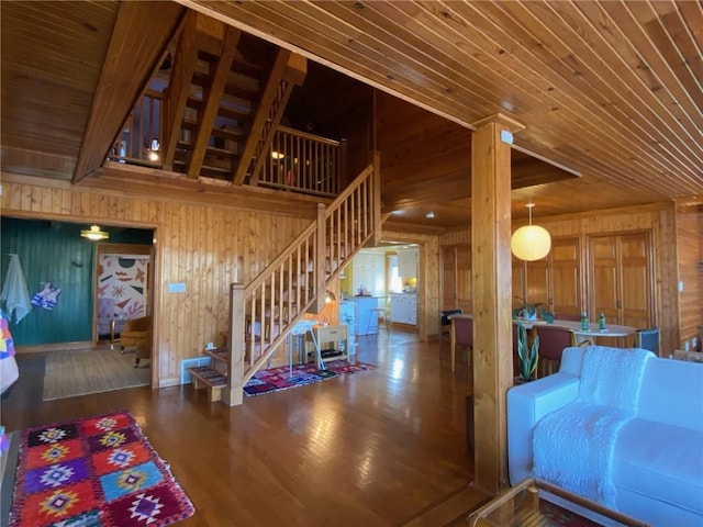 27 Beach Dr, Lake Tapawingo, MO 64015 - living room with wooden walls, wood finished floors, wood ceiling, and stairway