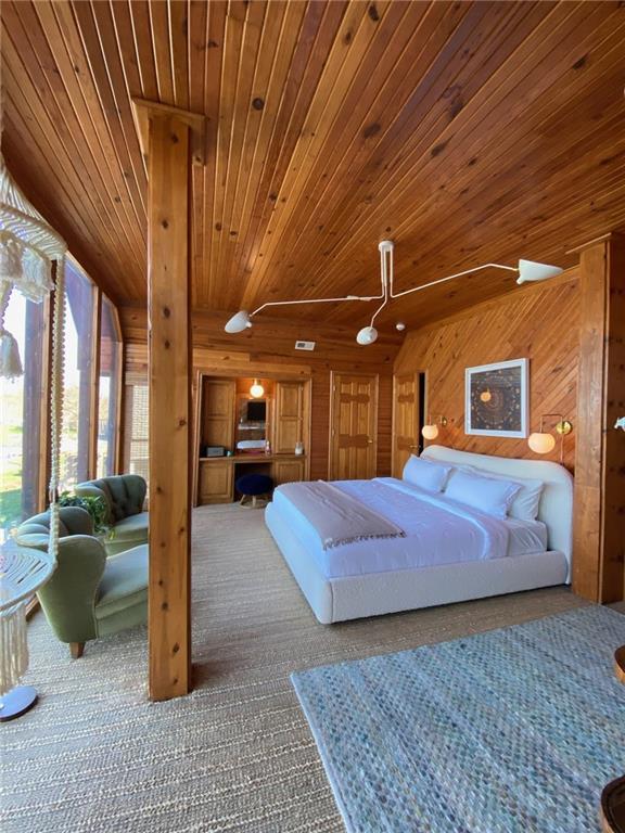 27 Beach Dr, Lake Tapawingo, MO 64015 - carpeted bedroom with wood ceiling and wood walls