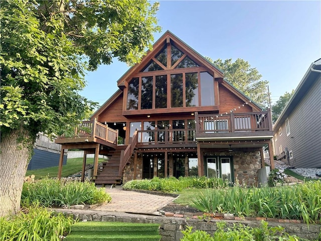 27 Beach Dr, Lake Tapawingo, MO 64015 - rear view of property featuring a deck, stone siding, and stairs