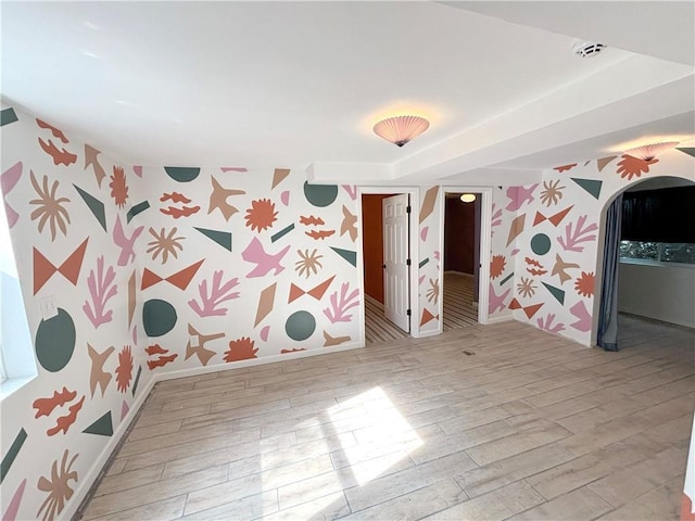 27 Beach Dr, Lake Tapawingo, MO 64015 - unfurnished room featuring wallpapered walls, arched walkways, wood finished floors, and a smoke detector