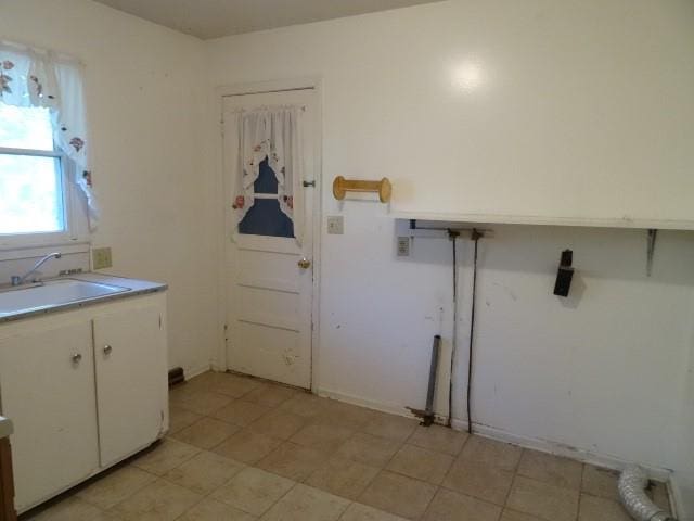 washroom featuring sink and cabinets