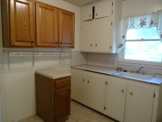 kitchen featuring white cabinetry and sink