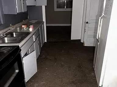 kitchen featuring black electric range and sink