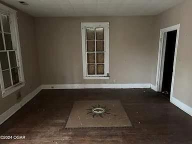 empty room with dark wood-type flooring