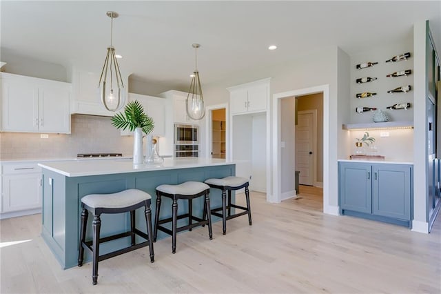 2202 W 178th Ter, Overland Park, KS 66085 - kitchen featuring stainless steel appliances, backsplash, white cabinets, light wood-style floors, and light countertops