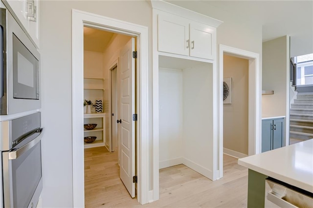 2202 W 178th Ter, Overland Park, KS 66085 - kitchen with stainless steel appliances, light wood-type flooring, white cabinetry, and light countertops