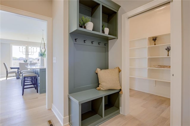 2202 W 178th Ter, Overland Park, KS 66085 - mudroom featuring light wood finished floors, a chandelier, and baseboards