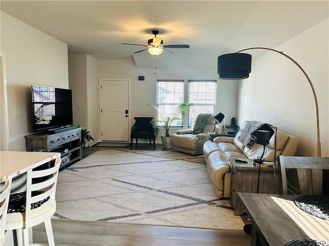 living room with ceiling fan and light hardwood / wood-style floors