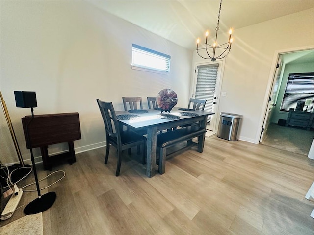 dining room with hardwood / wood-style flooring and a notable chandelier