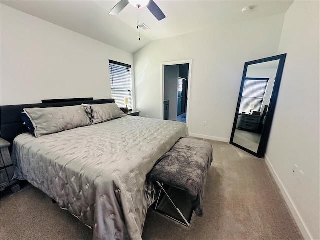 carpeted bedroom with ceiling fan, ensuite bath, and vaulted ceiling