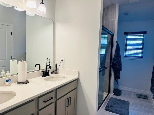 bathroom with hardwood / wood-style flooring, vanity, and a shower with shower door