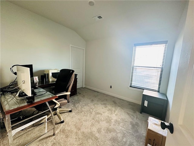 carpeted home office with lofted ceiling